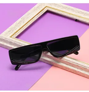 Detail view of square rhinestone sunglasses featuring crystal accents on black frames
