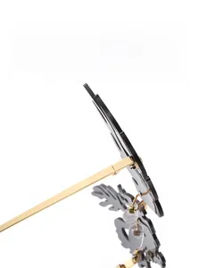 Detail view of avant-garde flame-shaped black lenses with gold metal temples and bridge