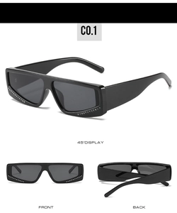 Detail view of square black sunglasses with rhinestone trim on the frame and wide temples