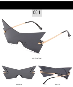 Three-angle views of oversized butterfly sunglasses with gold temples and jagged lens edges