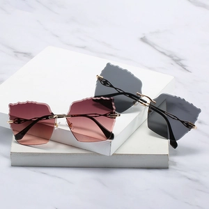 Modern rimless wave edge sunglasses with gold metal frames and gradient lenses