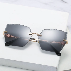 Rimless scalloped edge sunglasses with grey gradient lenses and gold metal frames