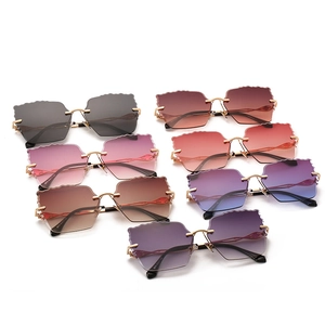 Frameless rimless sunglasses with wave cut lenses and golden metal temples in various colors