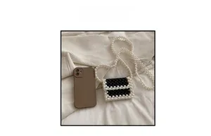Size comparison of a mini pearl woven crossbody bag next to a smartphone