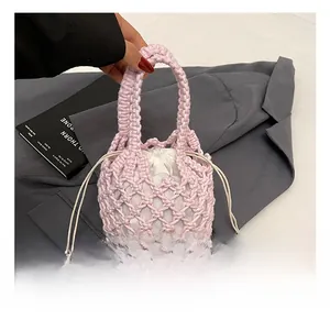 Detail of pink hand-crocheted bucket bag featuring a white canvas drawstring lining