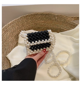 Detail of handmade mini bag featuring black and white woven pearl beads and shoulder strap