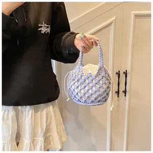 Detailed shot of lavender woven cotton rope handbag with white drawstring inner pouch