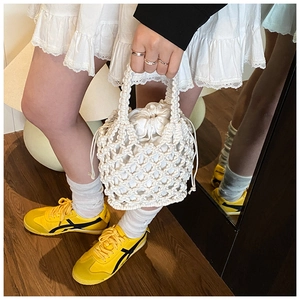 Close-up of white hand-woven cotton rope bag featuring a secure drawstring lining bag