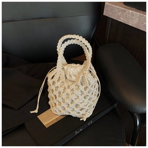 Detailed macro view of the macrame woven handbag with a drawstring inner lining