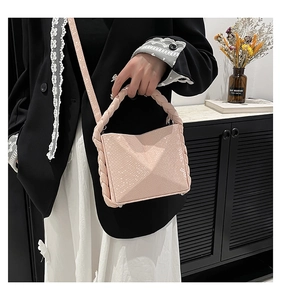 Detail of nude pink faux snakeskin handbag with woven handle and detachable shoulder strap