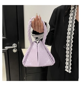 Detail of light purple triangular handbag with snake pattern leather and braided handle