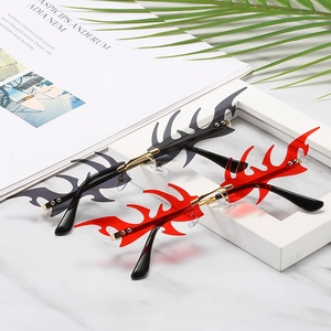 Frameless flame shaped sunglasses in black and red with punk Y2K metallic aesthetic