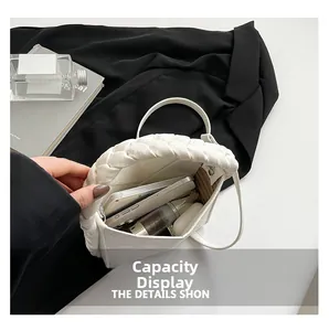 Top view of white leather bag showing interior capacity with striped lining and braided handle