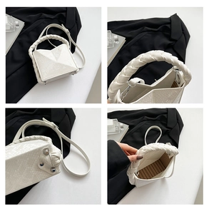 Detailed macro view of white snakeskin texture and woven handle on the handbag