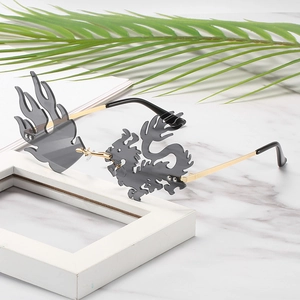 Exaggerated Chinese dragon and flame shaped sunglasses with gold temples and dark lenses