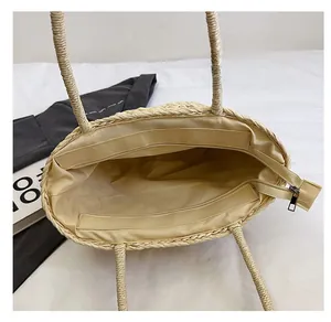Top view of woven straw bag interior with zipper closure and fabric lining details