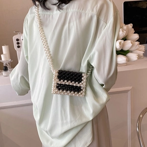 Handmade black and white woven pearl mini crossbody bag with long shoulder strap