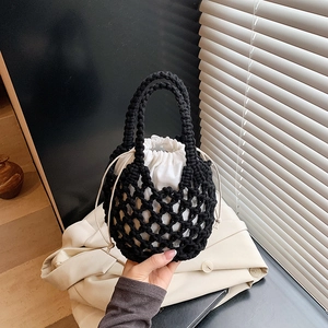 Handcrafted black woven cotton rope handbag with white drawstring liner for beach vacations