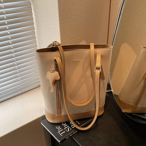 Chic beige and brown contrast bucket bag with WWTU logo and elephant charm