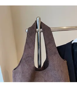 Detail view of dark brown corduroy tote bag featuring wide shoulder straps and vintage texture