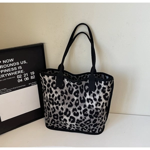 Macro shot of grey leopard print canvas tote bag with thick knit fabric and black trim