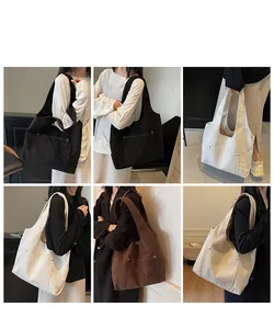 Corduroy tote bag in multiple colors featuring front pocket with metal buckle detail