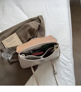 Detail view of large cream tote bag interior showing ample storage and metal twist lock