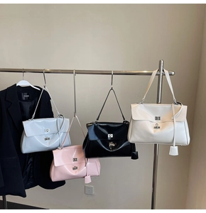 Detailed display of tote bags in blue, pink, black and white with silver twist locks
