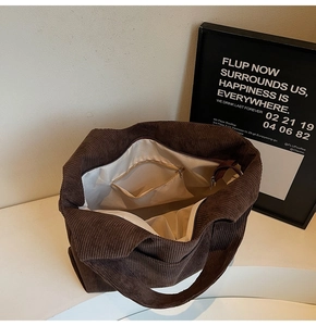 Interior detail of coffee corduroy tote bag showing large capacity and zipper pockets