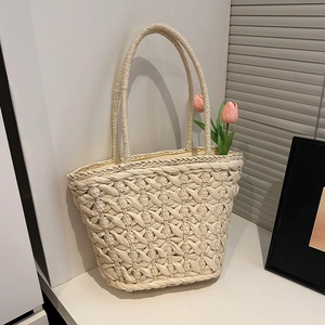 Handmade cream woven straw tote bag with large mesh pattern for summer beach vacations