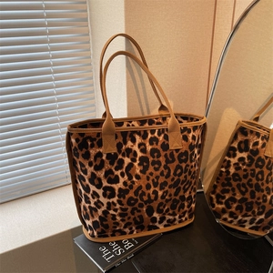 Leopard print canvas tote bag with brown woven handles and large capacity design