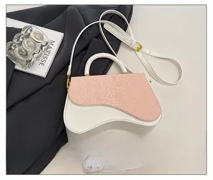 Detail of pink snakeskin pattern flap and white leather bag with golden hardware