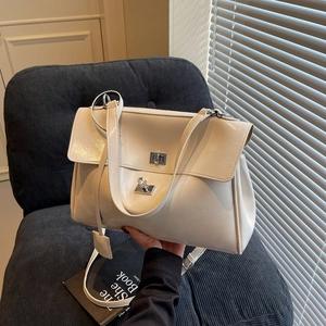 Off-white tote bag with silver double twist-locks and versatile shoulder strap