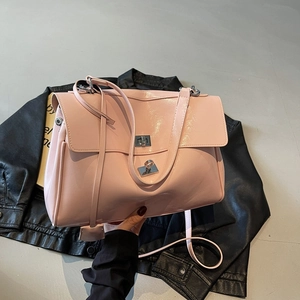 Pink glossy tote bag with silver twist lock and shoulder strap for office commuting