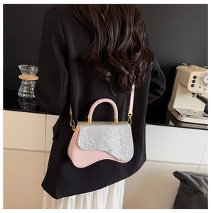 Pink and silver saddle bag with snakeskin texture shown from a stylish back perspective