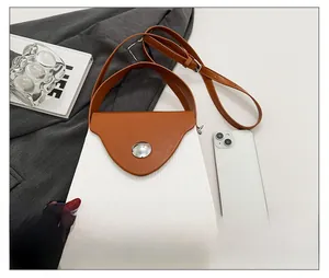 Detail showing color-block box bag with white striped texture and brown leather flap cover