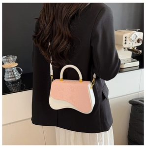 Detail of a pink snakeskin texture and white wavy design mini crossbody box bag