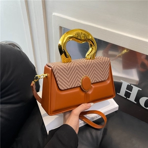 Modern orange and brown contrast box bag with artistic gold metal handle and long strap