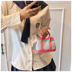 Mini tote bag in blue denim and pink faux leather shown in a mirror selfie scene