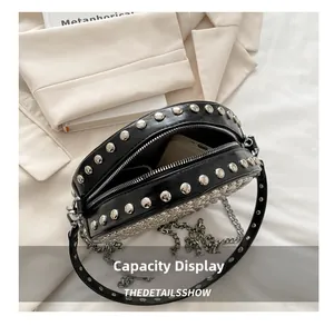 Detail showing the internal storage capacity of the black rivet crossbody bag with phone