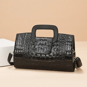 Black crocodile-embossed tote bag with square cutout handle and gold hardware