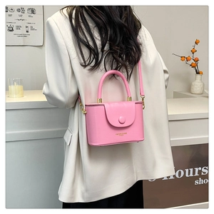 Pink leather crossbody box bag with magnetic flap closure and matching top handle