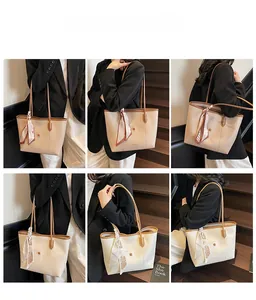 Detail view of khaki and cream tote bags with decorative scarves on leather handles