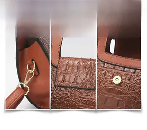 Close-up of brown crocodile texture leather bag with gold metal hardware and magnetic buckle