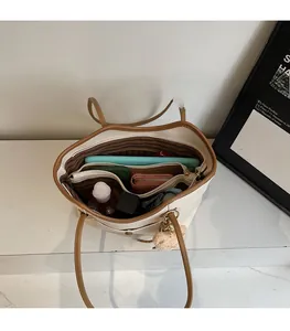 Spacious interior of beige tote bag with functional compartments for tablets and essentials