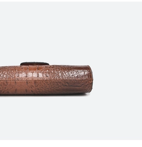 Detail view showing crocodile embossed leather texture and stitching on the tote bag bottom