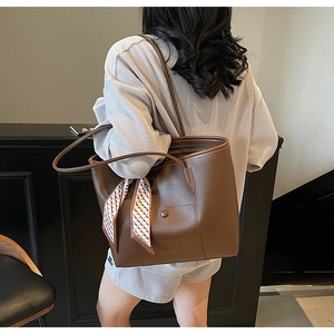 Dark brown large tote bag with silk scarf detail shown on shoulder for size perspective