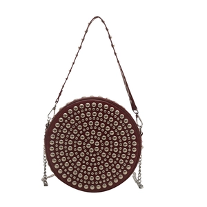 Burgundy round rivet crossbody bag with silver studs and chain strap in white background