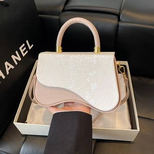 Beige saddle-shaped handbag with snake pattern texture and gold-tone hardware