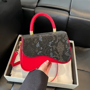 Fashionable red and black contrast saddle bag with snakeskin print flap and long strap